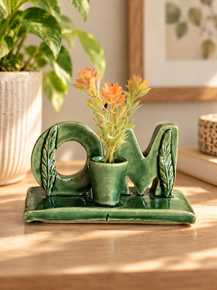 Green OM holder used as a tiny planter