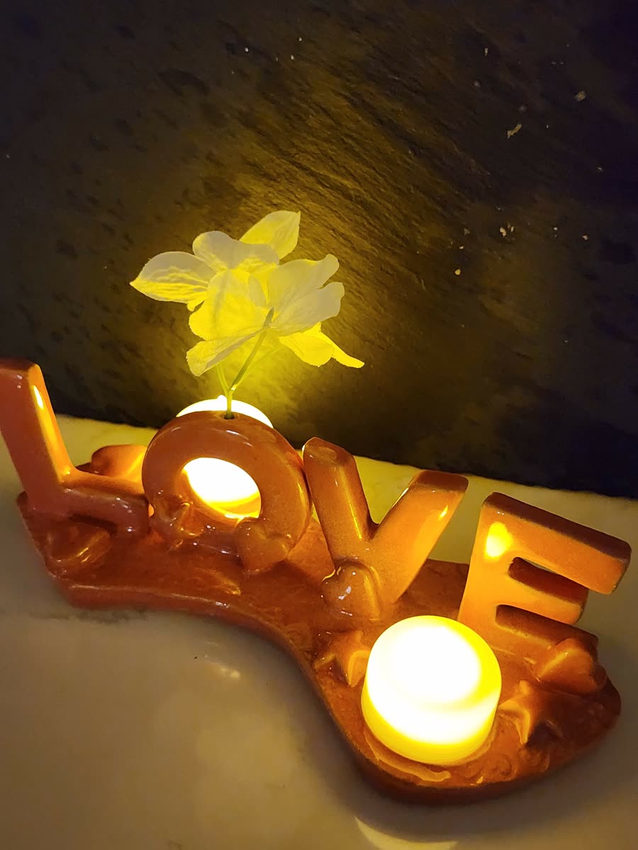 LOVE candle holder glowing at night